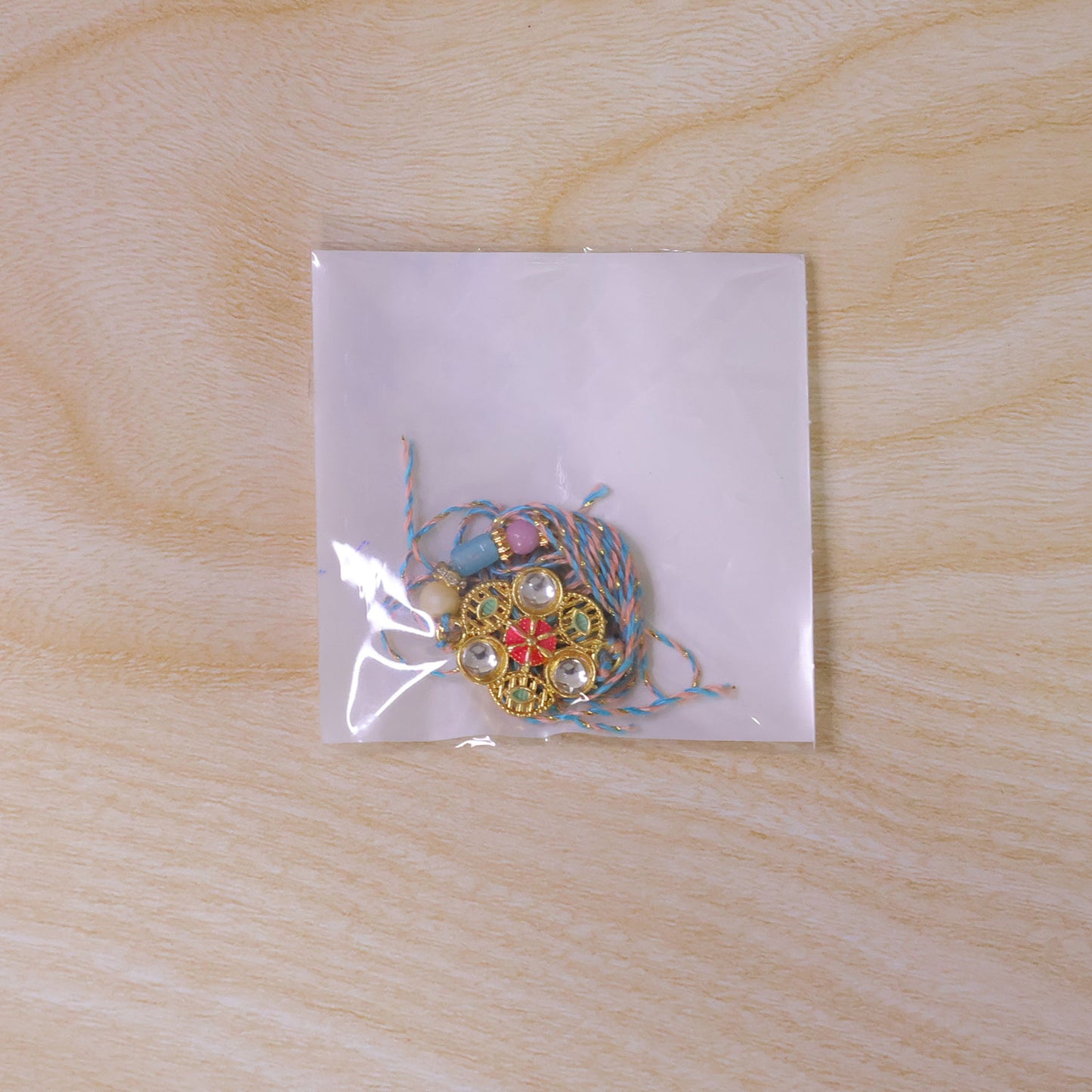 Blue Pink Floral Rakhi with Gold Medallion and Soft Festive Brother Gift Styling