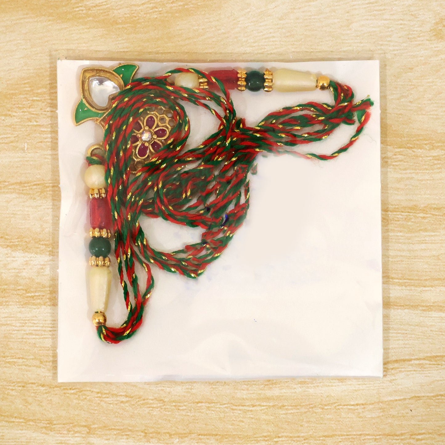 Classic Rakhi featuring Kalash Charm and red stone accents in chain look for Gift Use