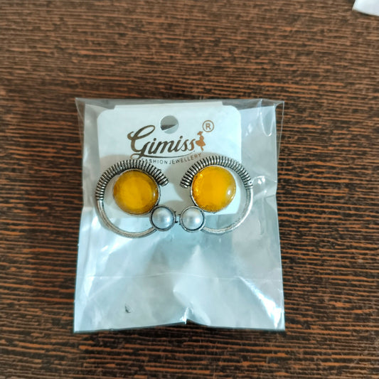 Oxidized silver half-halo stud earrings with yellow citrine glass and pearl on white background