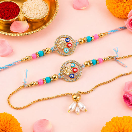 Two colorful Rakhi bracelets with evil eye beads and a gold lumba, surrounded by pink petals and orange flowers.