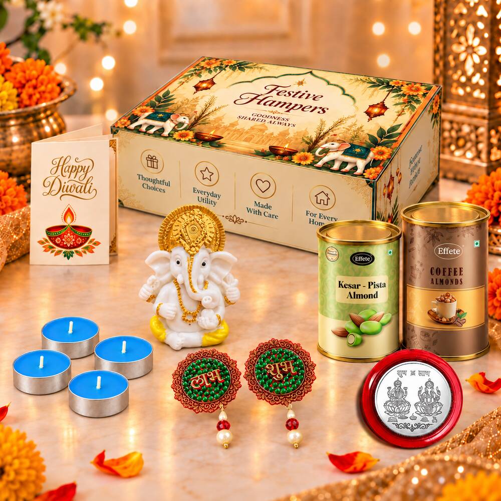 A festive hamper box, Ganesha idol, four blue tealights, Diwali card, two almond tins, two decorative hangings, and a silver