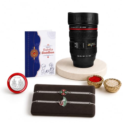 A Rakshabandhan gift set includes two silver bracelets, a greeting card, a camera lens-shaped mug, and small bowls of red