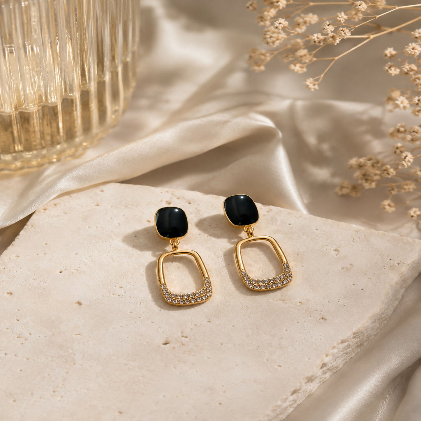 Close-up of Korean-inspired geometric gold plated earrings with black stones