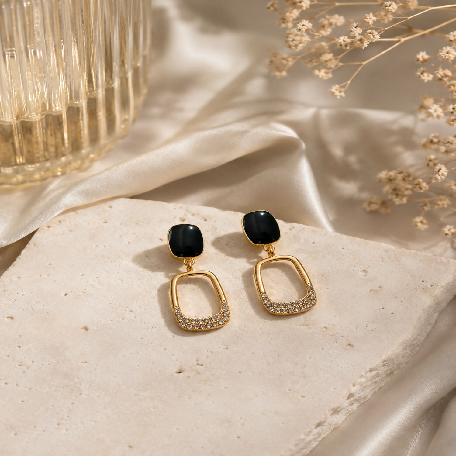 Close-up of Korean-inspired geometric gold plated earrings with black stones