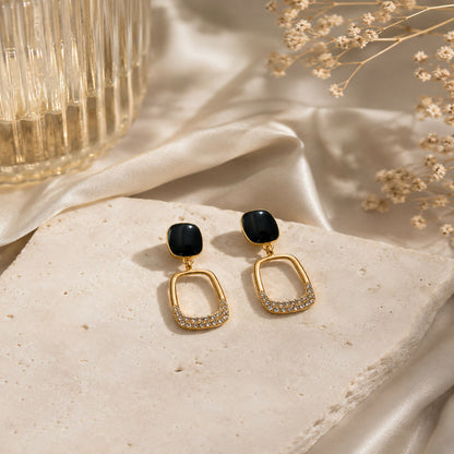 Close-up of Korean-inspired geometric gold plated earrings with black stones