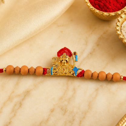 Auspicious golden deity Rakhi for brother with sandalwood beads for Raksha Bandhan.