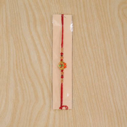 Tiny Trishul Damru Rakhi with Green Stone Center and Minimal Red Thread