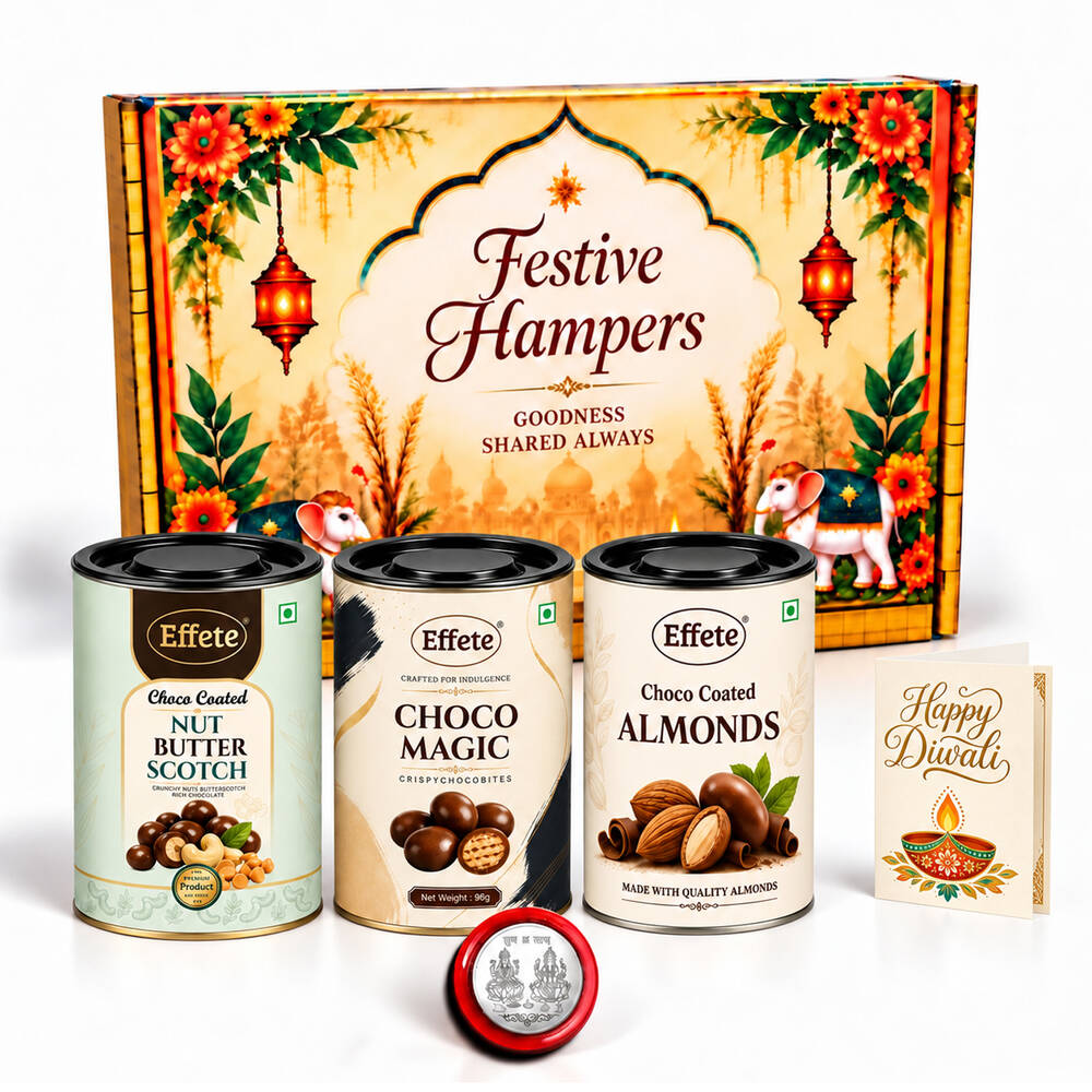 A festive gift hamper with three tins of chocolates and nuts, a silver coin, and a greeting card.