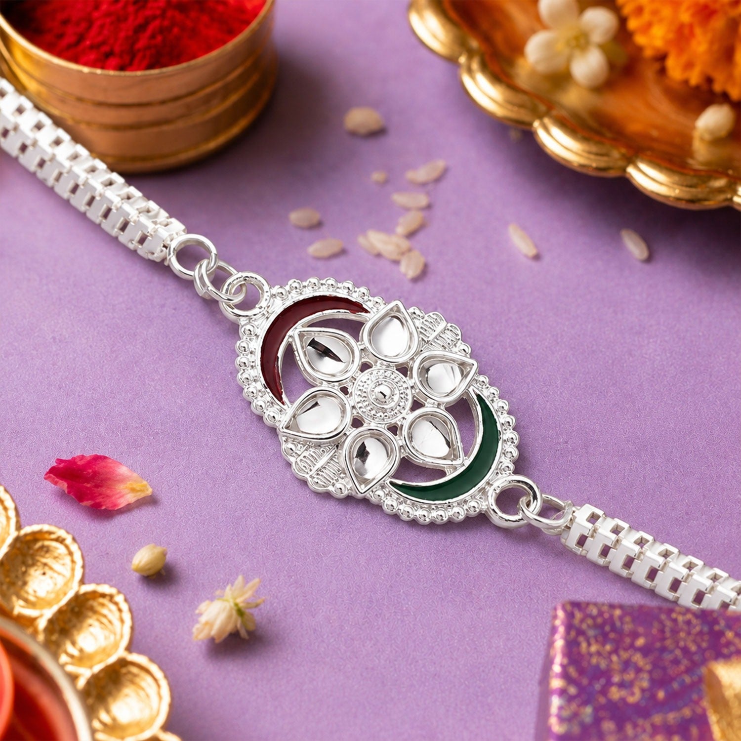 Elegant Silver Rakhi featuring tricolor accents and intricate chain link design displayed on festive background.