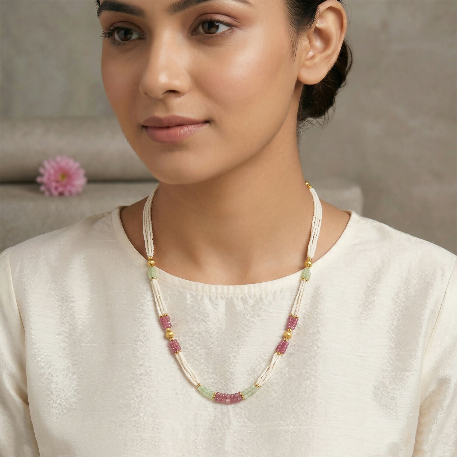 Front view of multi-layer pearl mala necklace featuring pink and mint beads