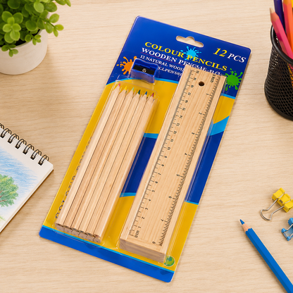 A 12-piece wooden colored pencil set, ruler, and sharpener are packaged in clear plastic on a wooden desk.