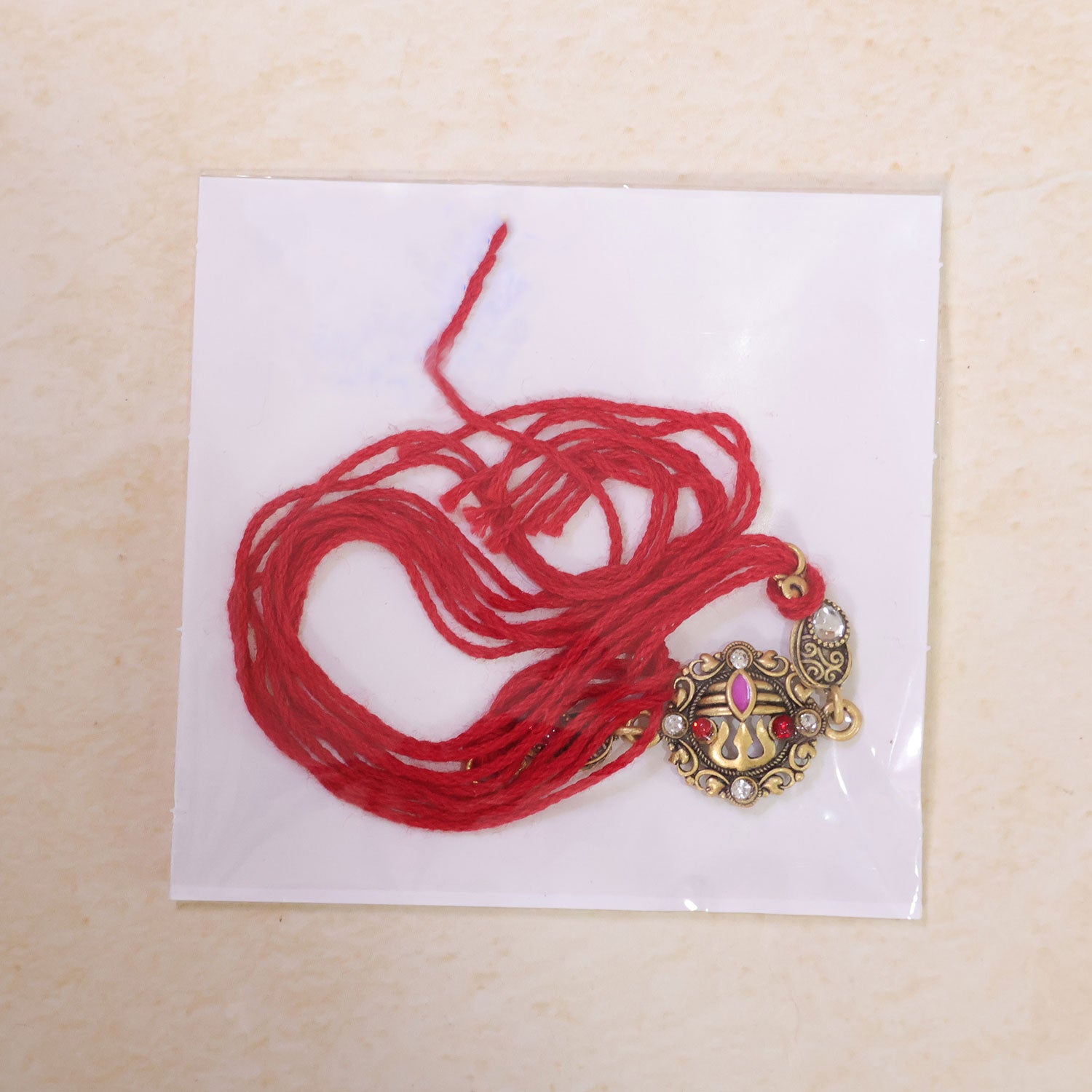 Premium Rakhi showcasing Ornate Floral Medallion, gold trims and gift style for Gift