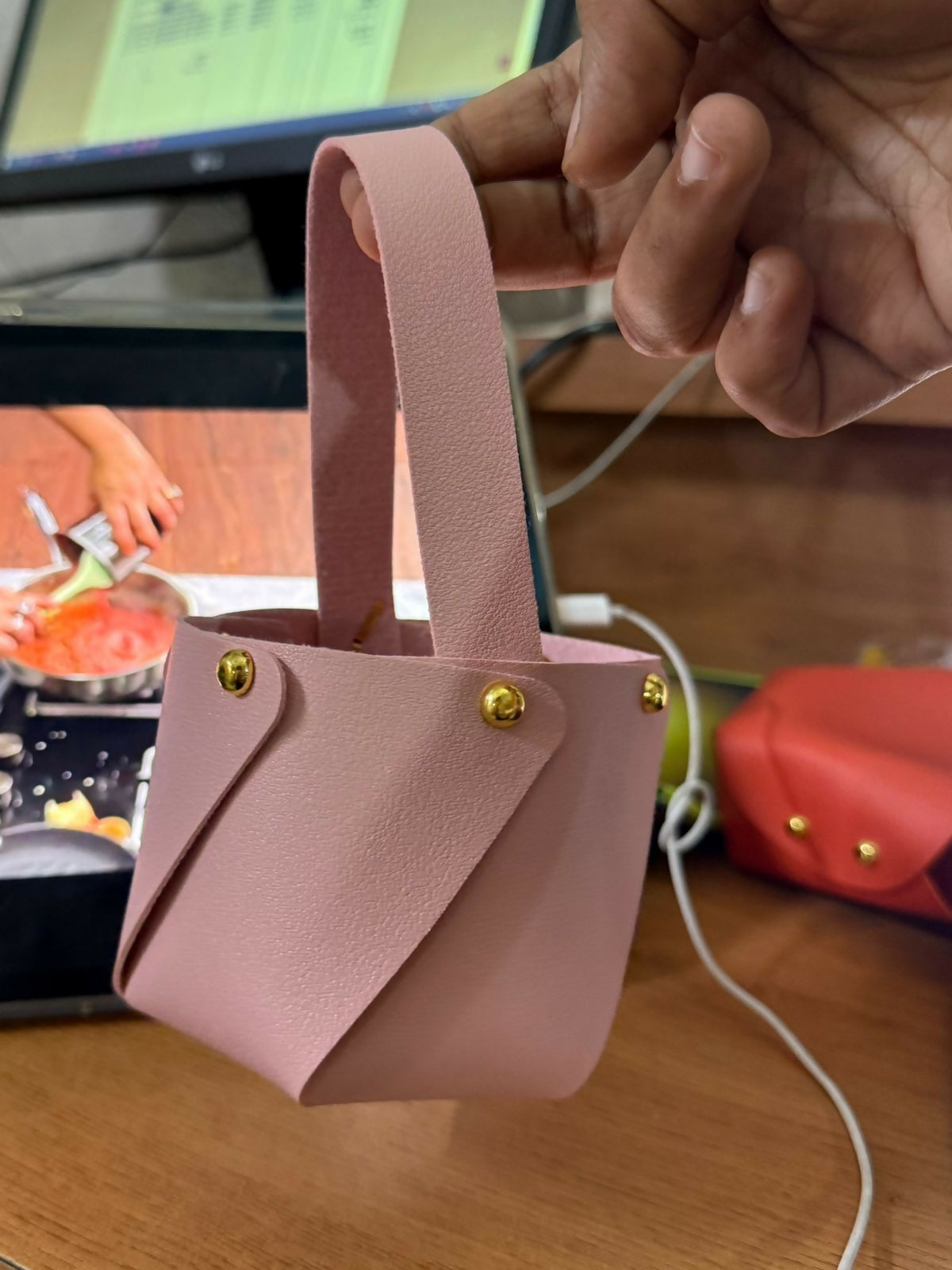Pink mini bucket handbag close-up on smooth textured material
