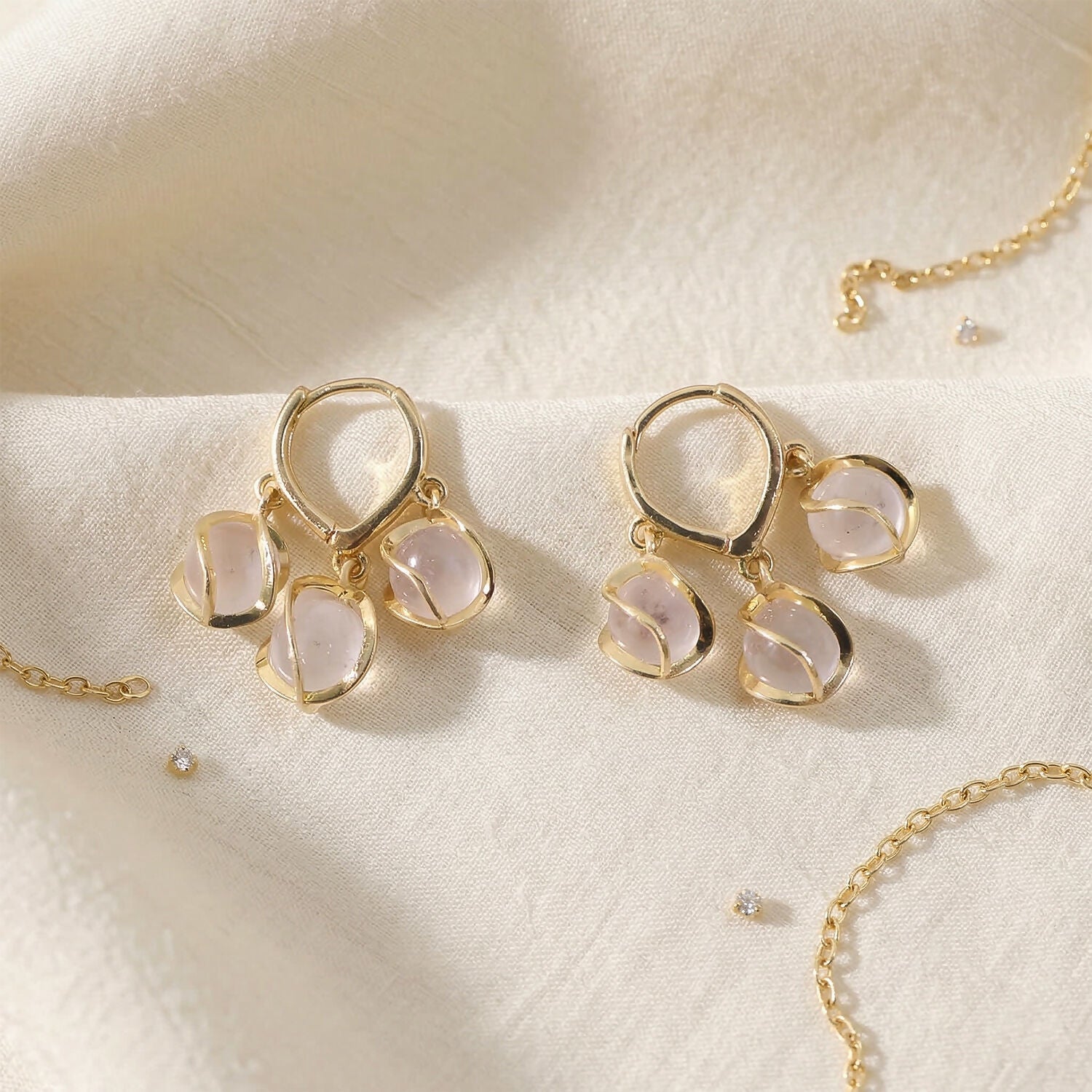 Gold hooped earrings with shimmering opal stones