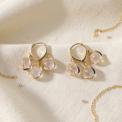 Gold hooped earrings with shimmering opal stones