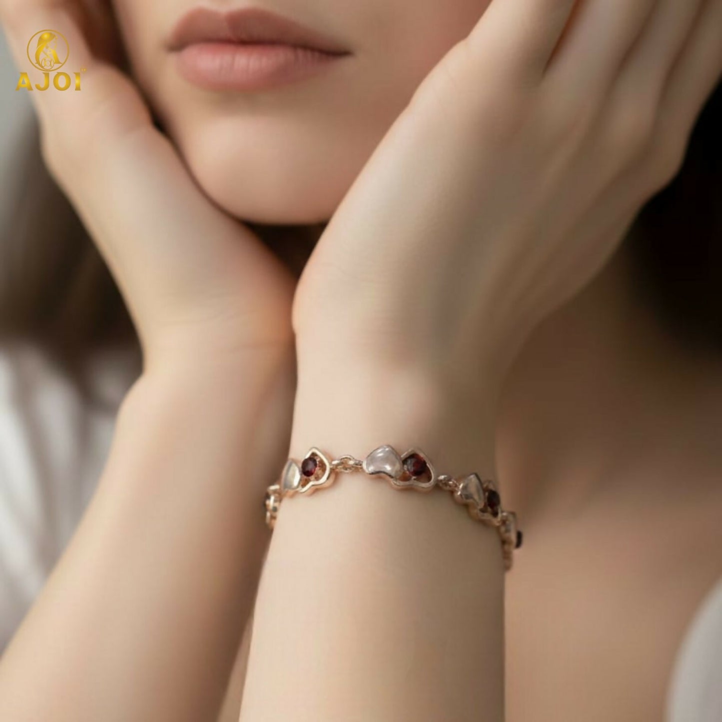 Elegant gold finish bracelet showcasing alternating heart motifs with pearl-style accents