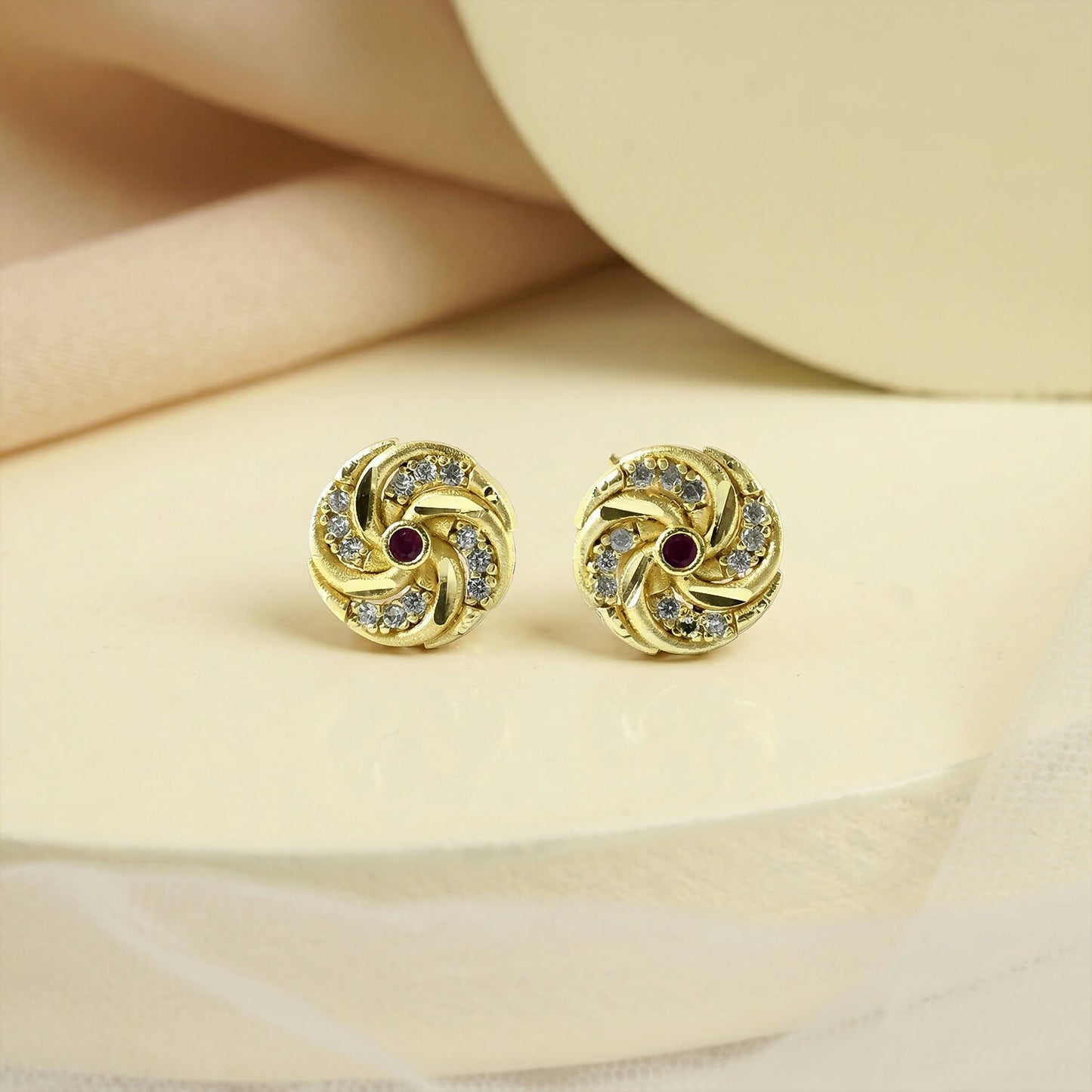 Pair of gold stud earrings with red stones, suitable for gifting