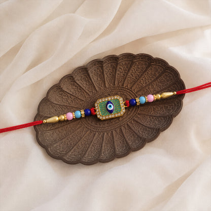 Stylish Evil Eye Rakhi with mint green thread front view