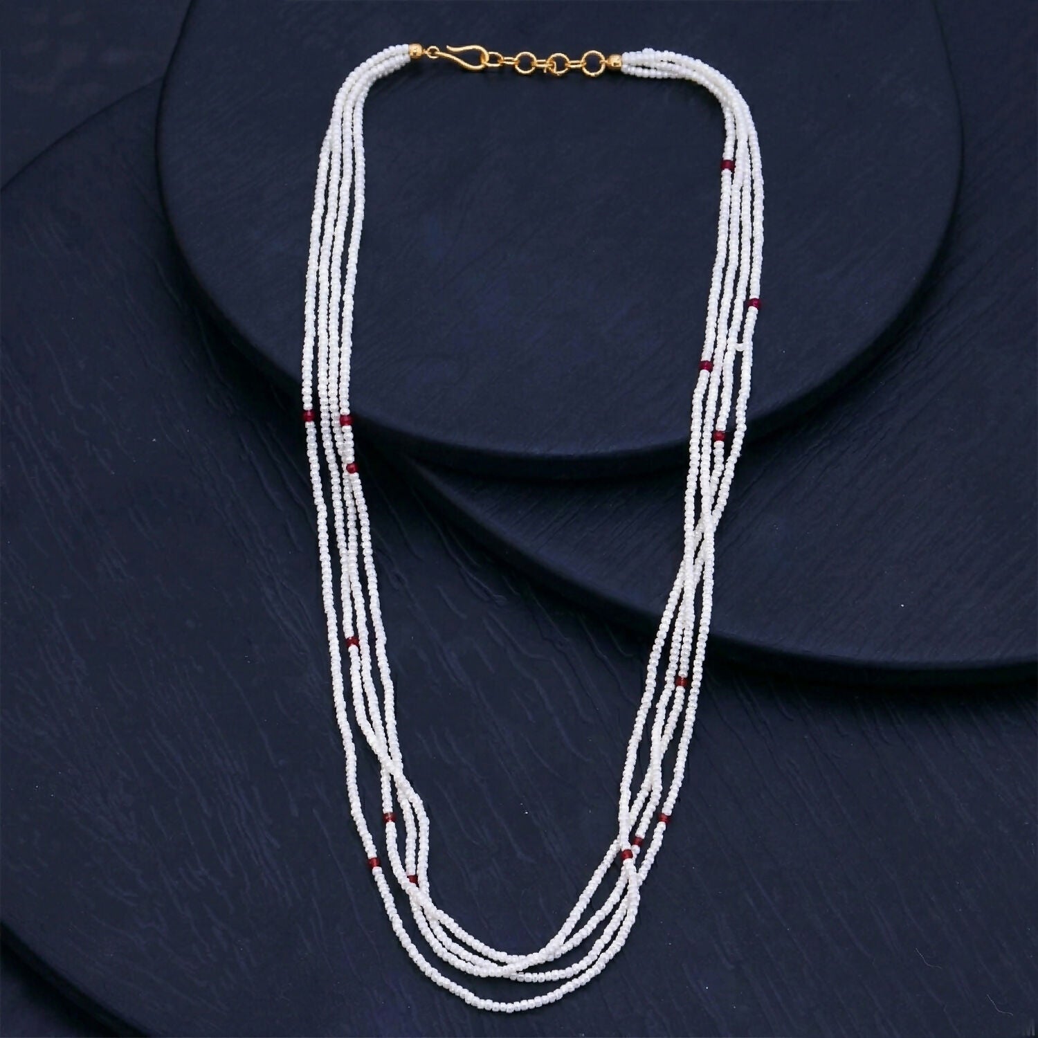 Multi-layer white mala necklace draped gracefully
