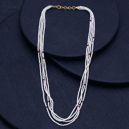 Multi-layer white mala necklace draped gracefully