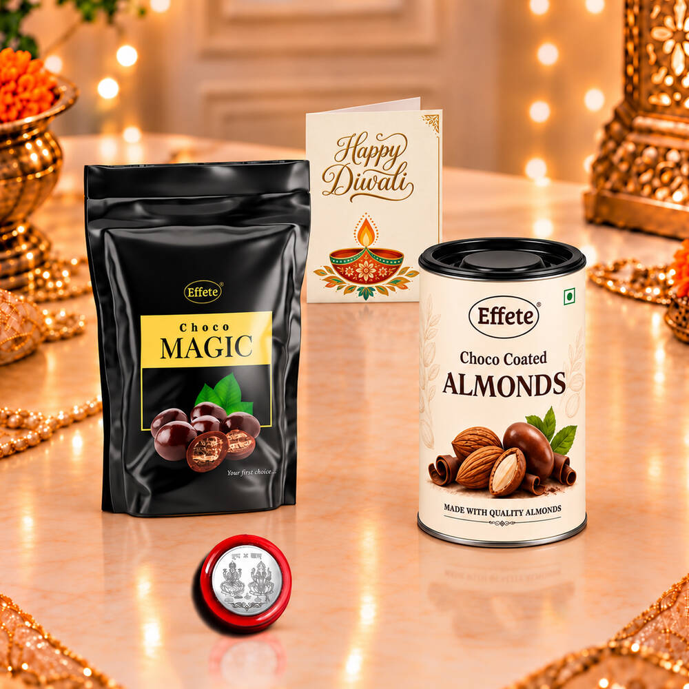 A black pouch of Choco Magic, a tin of Choco Coated Almonds, a silver coin, and a greeting card on a decorated table.