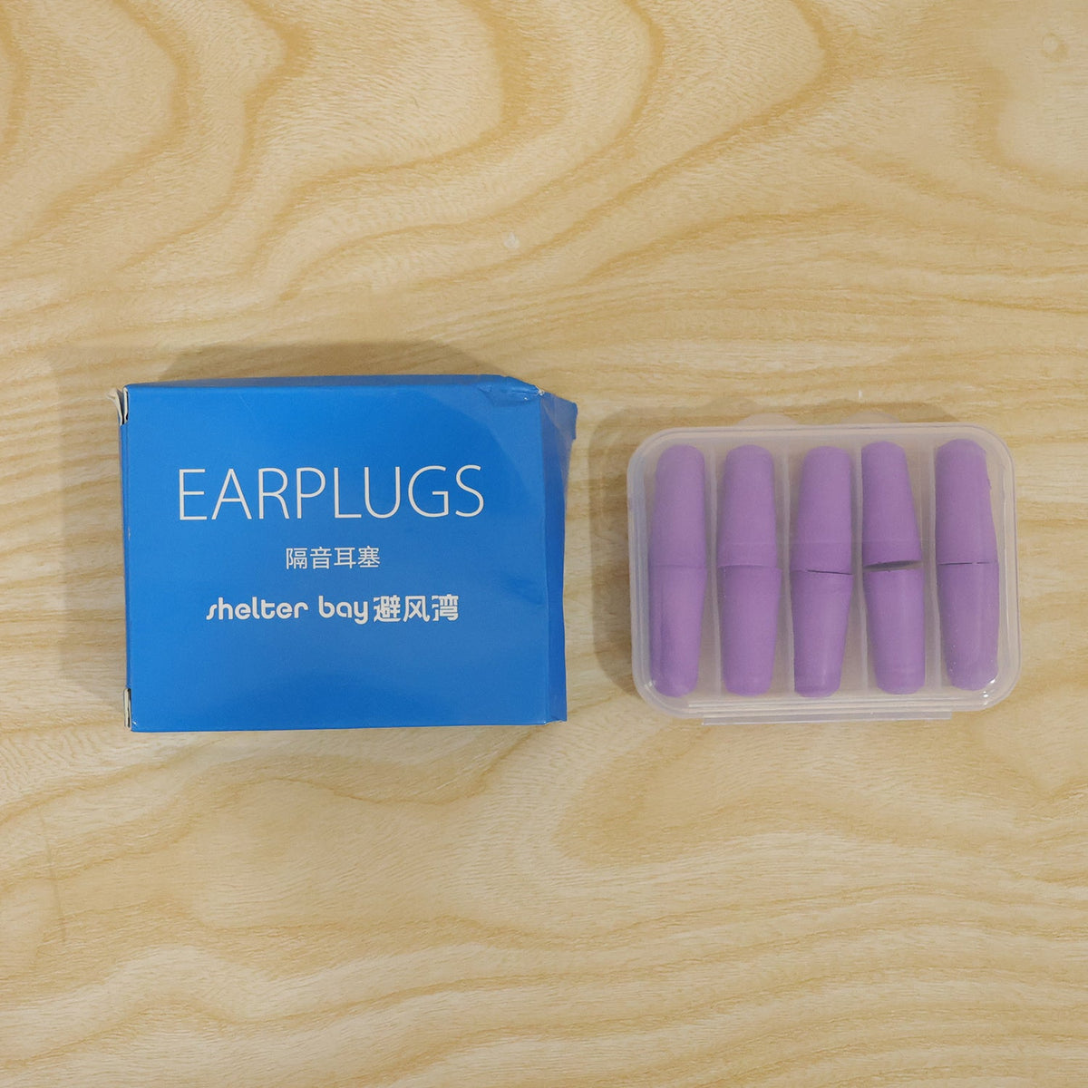 Multiple purple foam earplugs shown with the clear storage case.