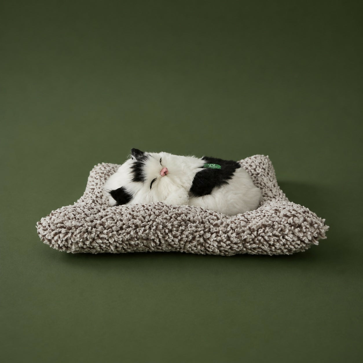 Sleeping cat plush toy displayed on desk