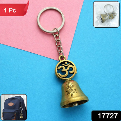 Om temple bell keychain attached to car keys, showing utility