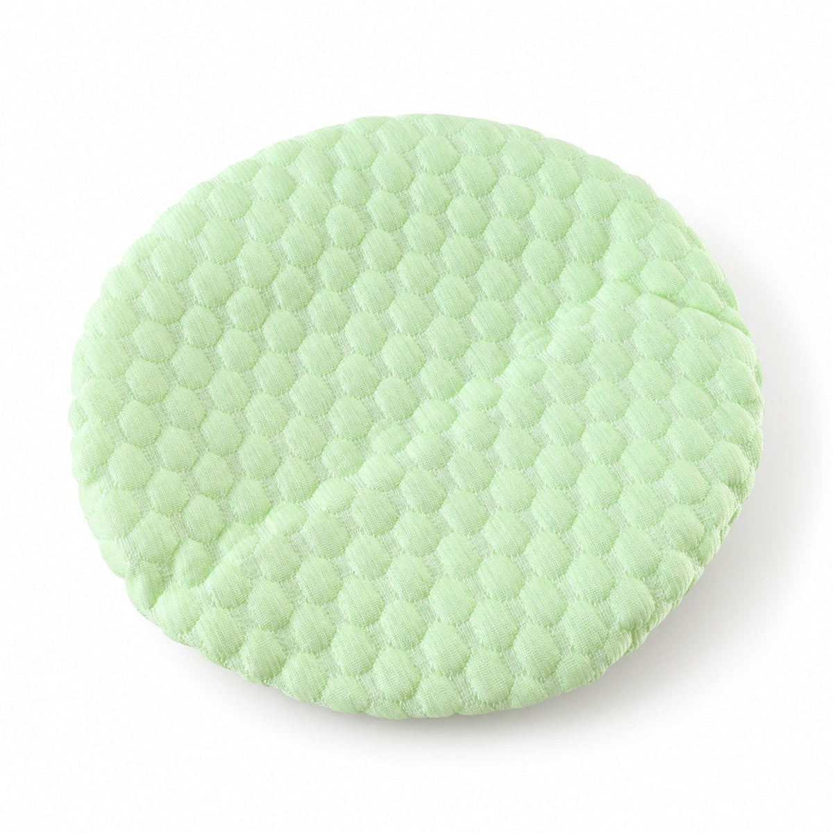 Light green textured round cushion cover with a honeycomb pattern on a plain white background.