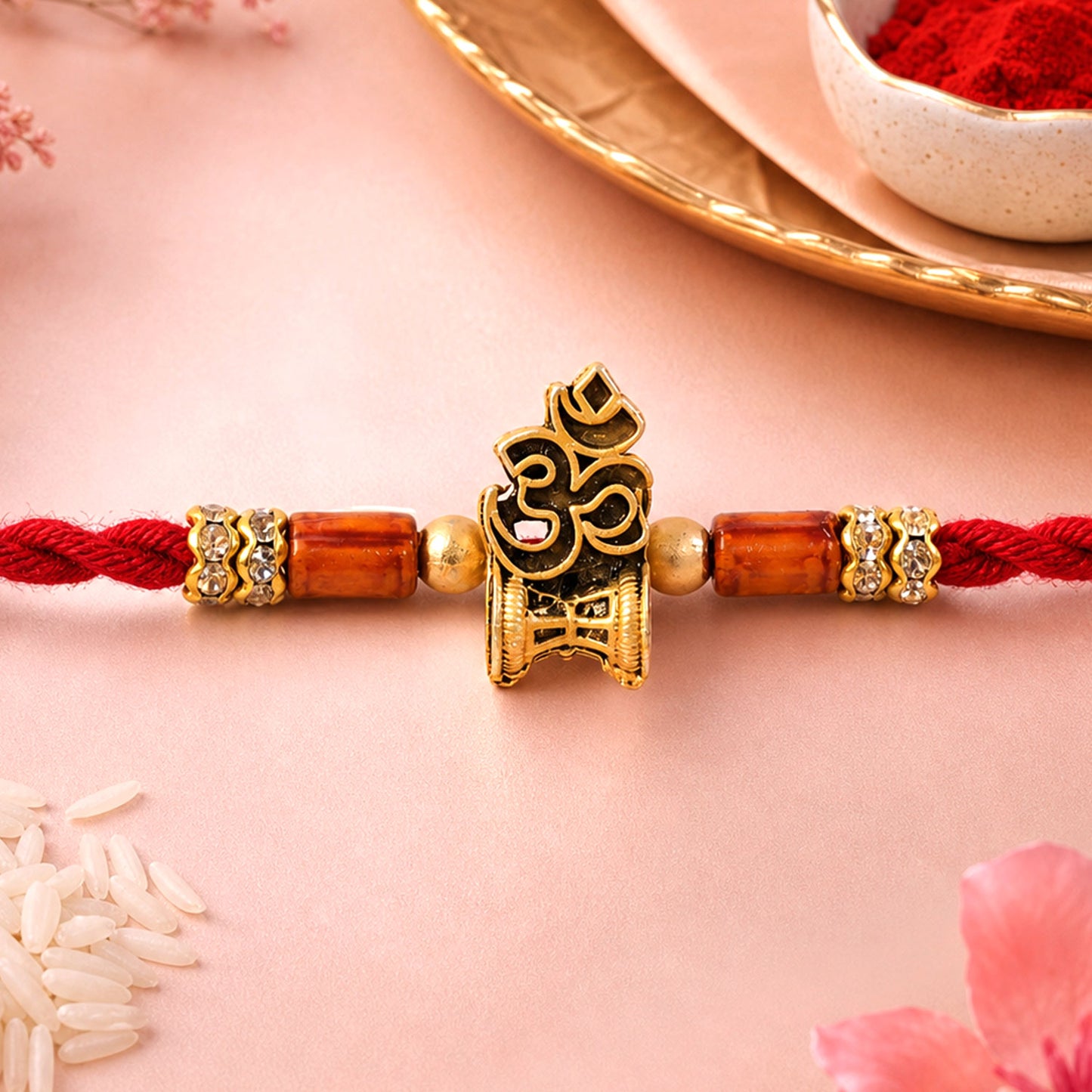 Red Braided Rakhi with Golden Om Pendant and Warm Amber Beads