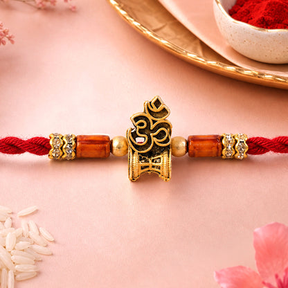 Red Braided Rakhi with Golden Om Pendant and Warm Amber Beads