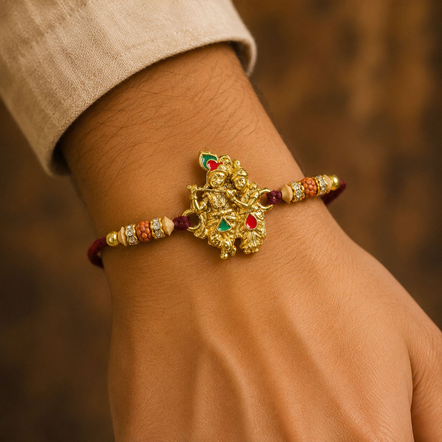 Radha Krishna Golden Devotional Rakhi with Couple Idol Centre and Color Stones