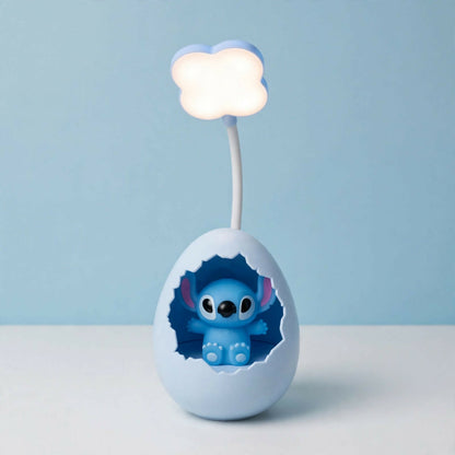 A light blue cracked egg lamp with a Stitch figure inside and a glowing cloud light on a flexible arm, against a plain blue