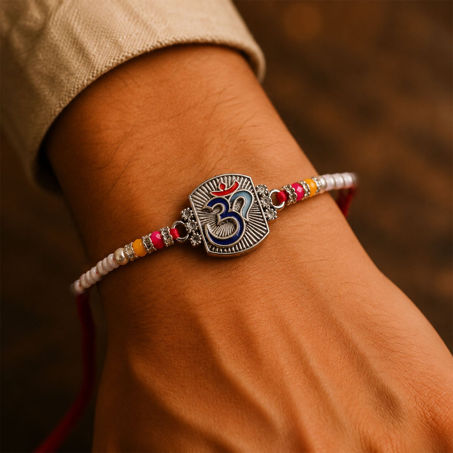 Om Symbol Silver Centre Rakhi with White Beads, Roli Chawal Coin and Peacock Gift Packing