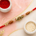 Red Thread Rakhi with Amber Beads and Antique Gold Lantern Charm