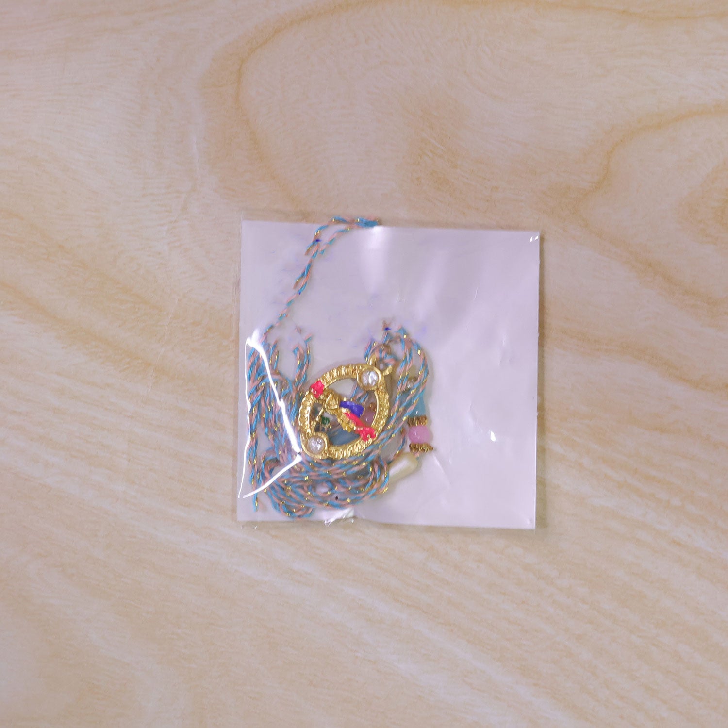 Colorful Circular Charm Rakhi with Pink Blue Beads and Festive Brother Gift Appeal