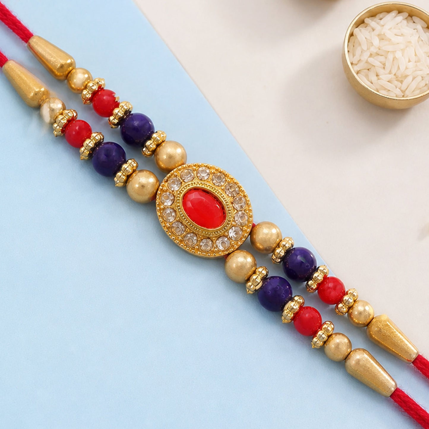 Red Blue Beaded Rakhi with Ruby Center and Rich Traditional Festive Gift Styling