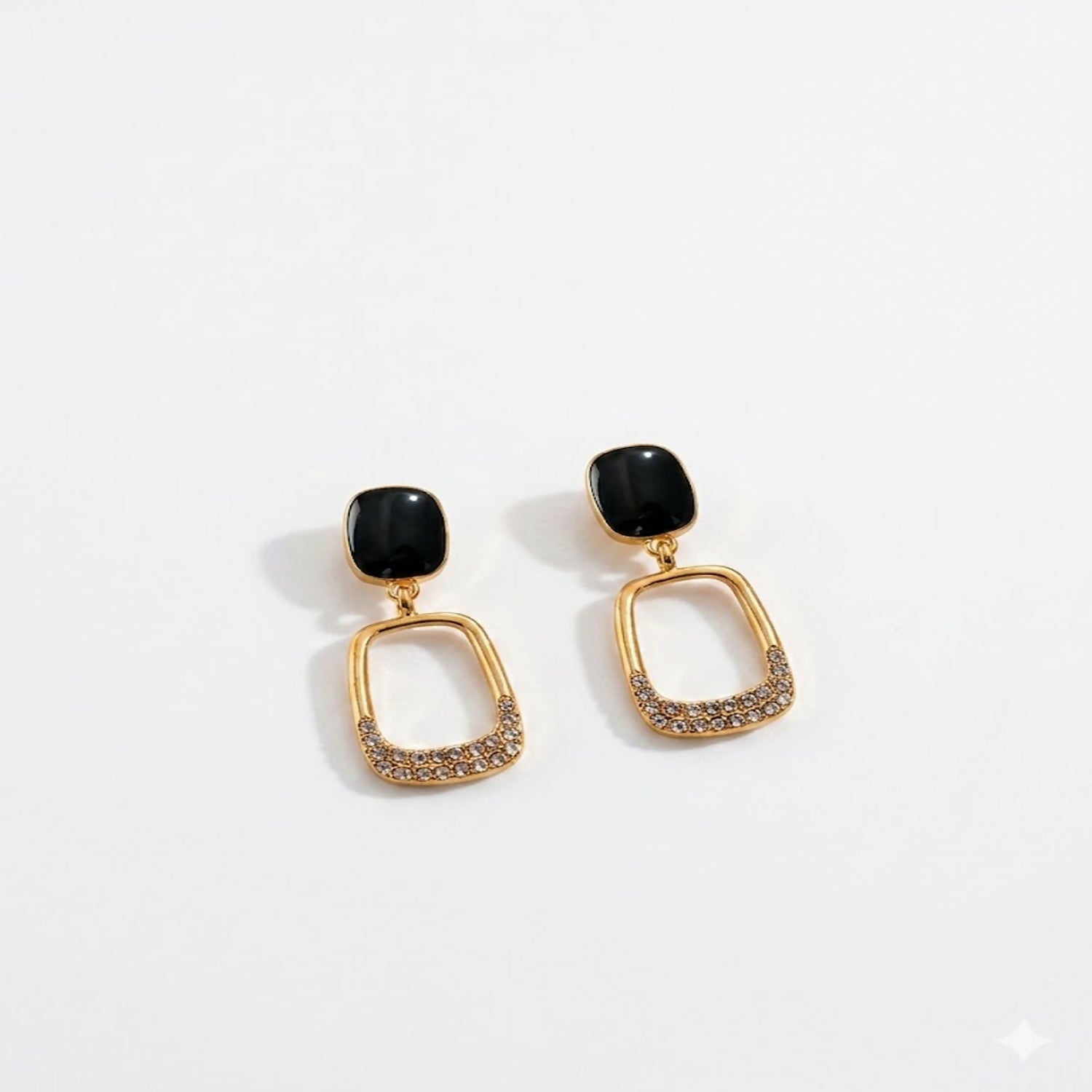 Side view of black stone gold plated geometric drop earrings