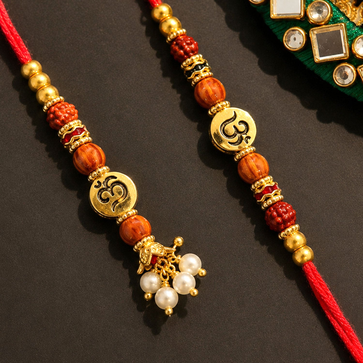 Om Motif Bhai Bhabhi Rakhi with Rudraksha Beads, Wooden Beads and Pearl Drop Charms