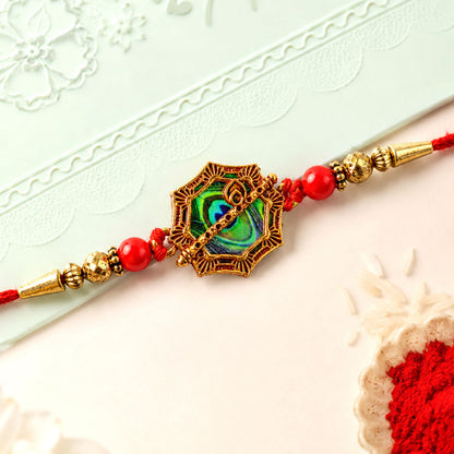 Shop Peacock Feather Rakhi Golden Frame Red Beads (5pcs)