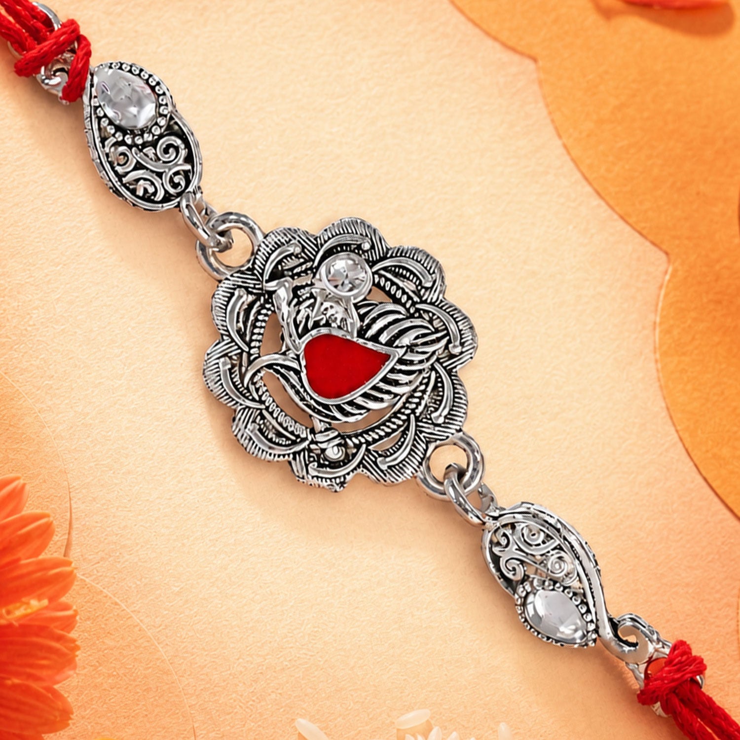 Ornate Rakhi featuring Silver Round Charm, metal trims and chain look for Gifting