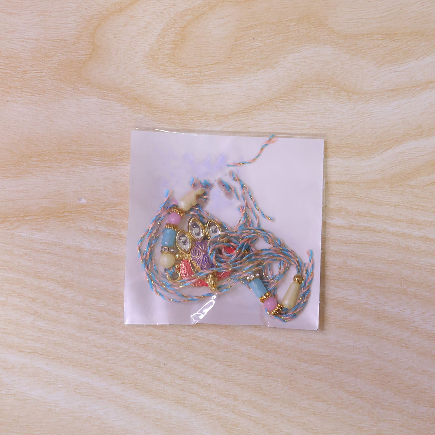 Coral Enamel Medallion Pendant Rakhi with Kundan Teardrop Stones