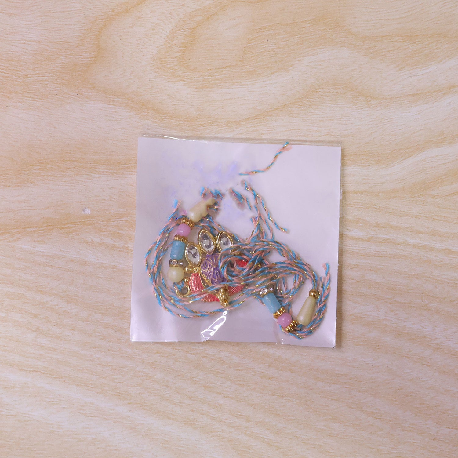 Coral Enamel Medallion Pendant Rakhi with Kundan Teardrop Stones