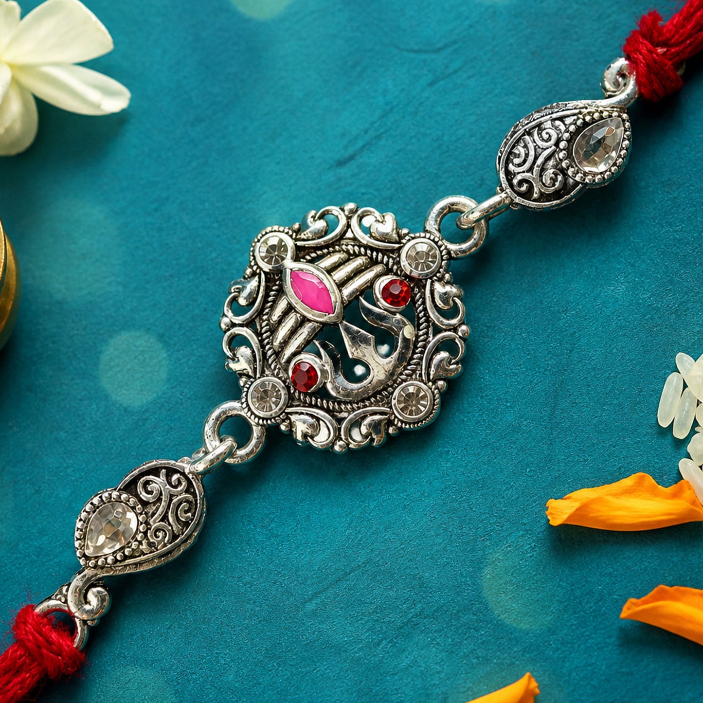 Premium Rakhi showcasing Silver Om Leaf Charm, gold trims and chain look for Gift