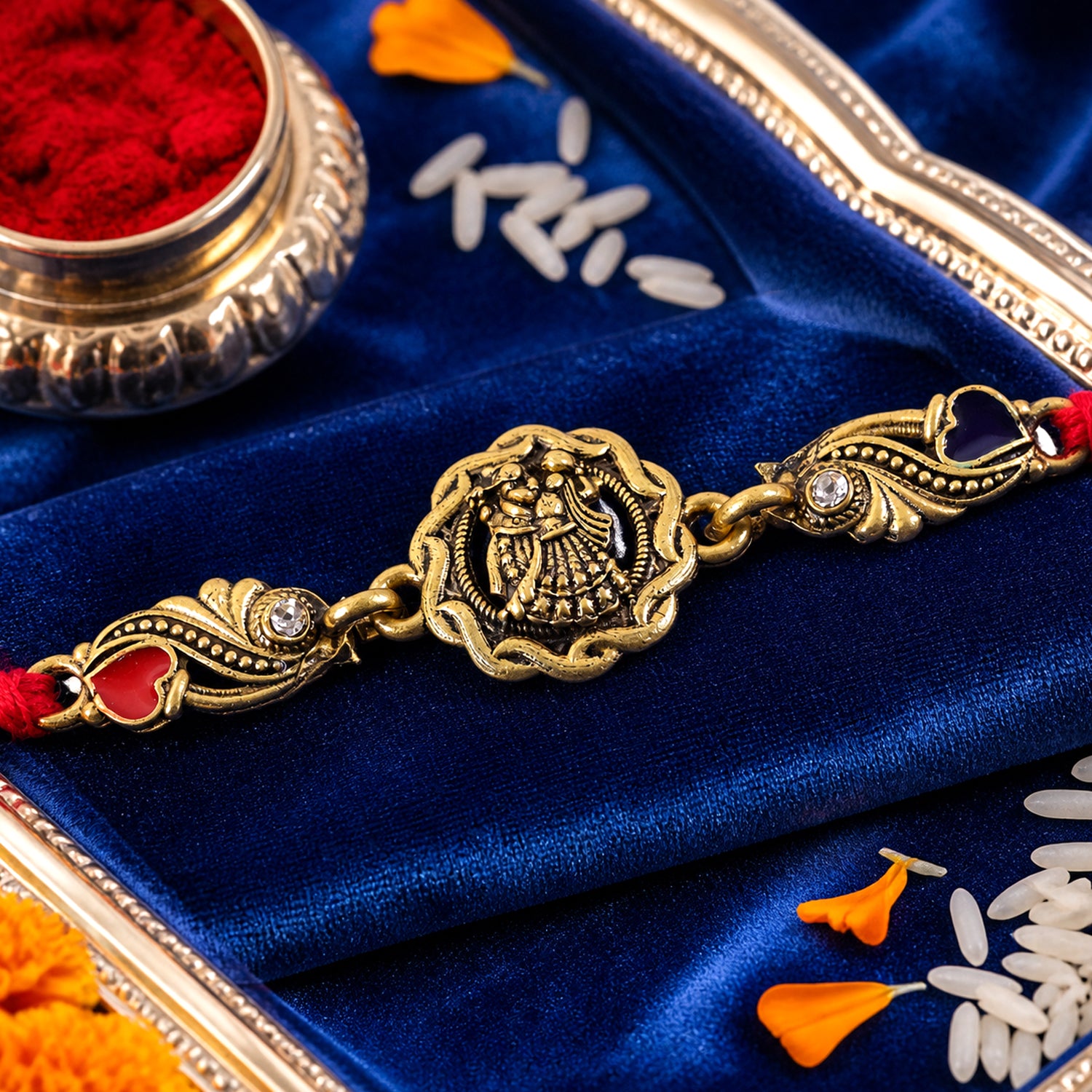 Antique Gold-Toned Radha Krishna Rakhi with Crystal Accents, Enamel Hearts & Red Thread