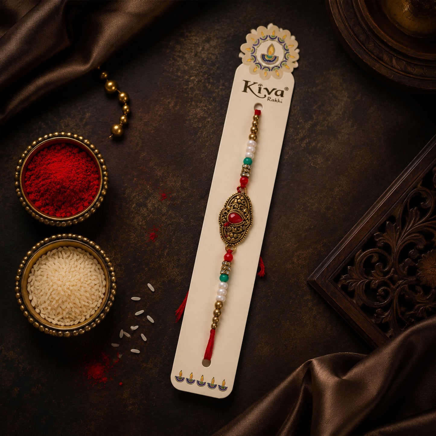 Antique Gold Teardrop Designer Rakhi with Red Stone, Roli Chawal Coin and Diya Gift Packing