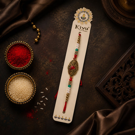 Antique Gold Teardrop Designer Rakhi with Red Stone, Roli Chawal Coin and Diya Gift Packing