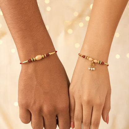 Couple Rakhi with Peach Oval Center Bead and Pearl Drop Charm