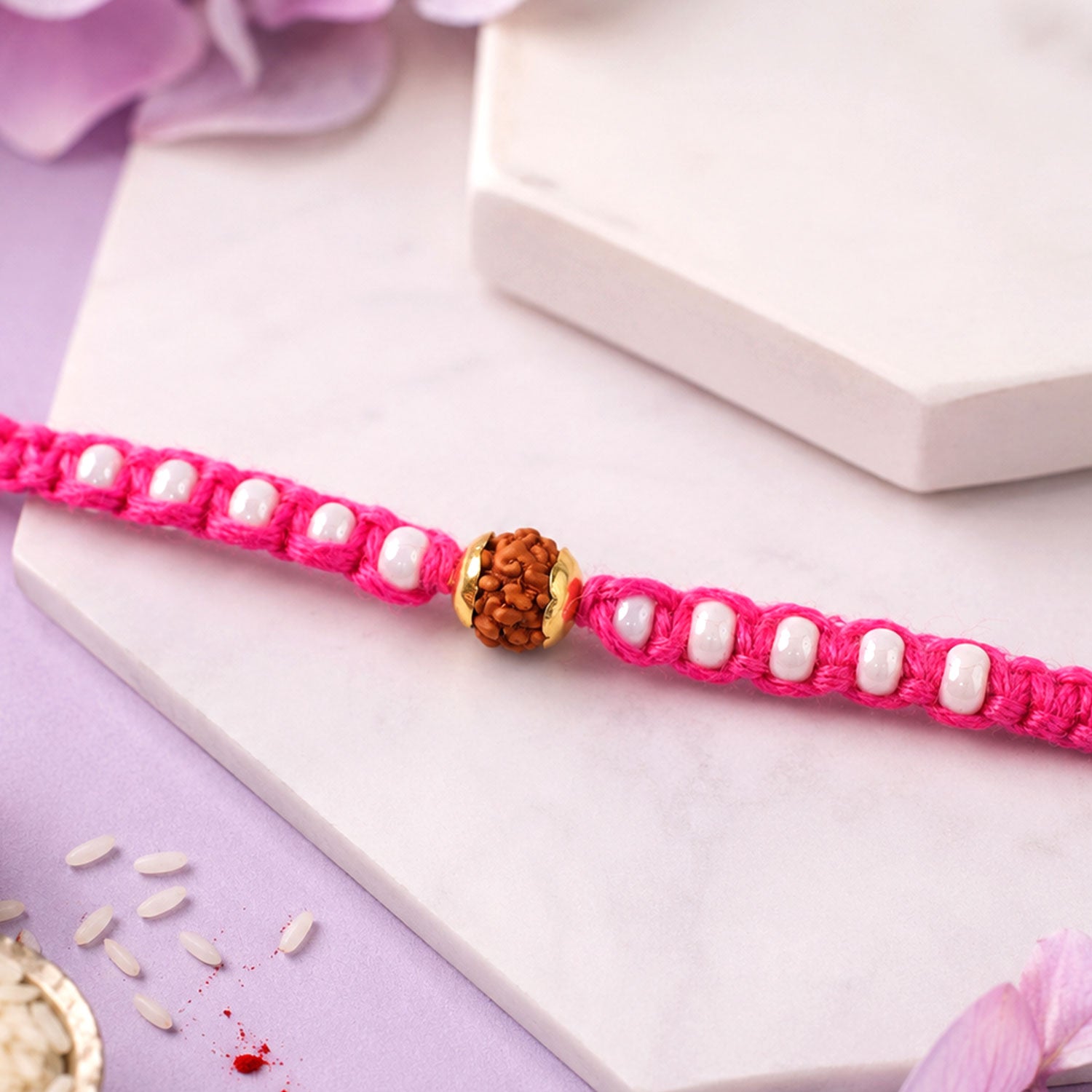 Pink-White Braided Rakhi with Natural Rudraksha Bead Pendant
