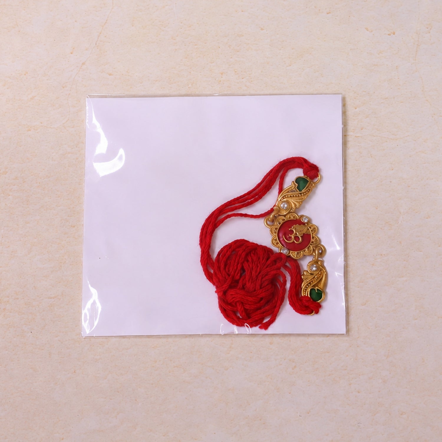 Elegant Rakhi featuring Om Plaque, crystal accents and thread style for Gift Styling